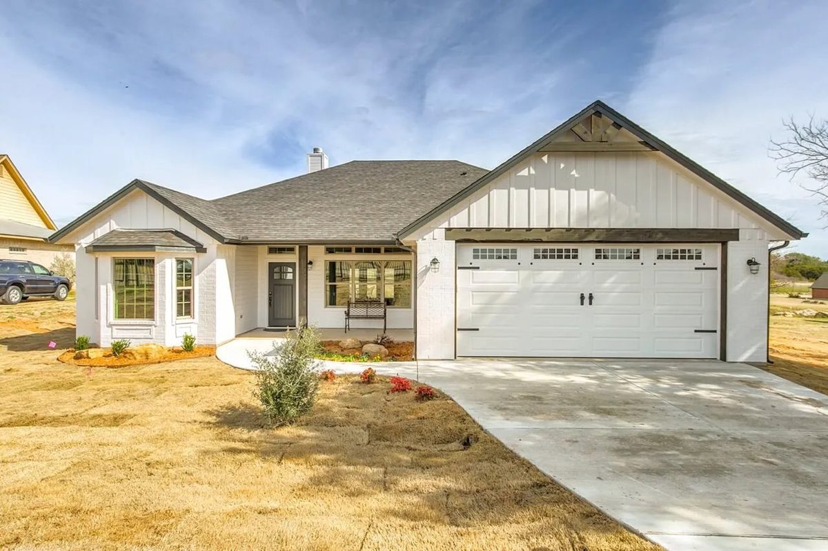 White board-and-batten ranch-style new construction home in Glen Rose, Texas
