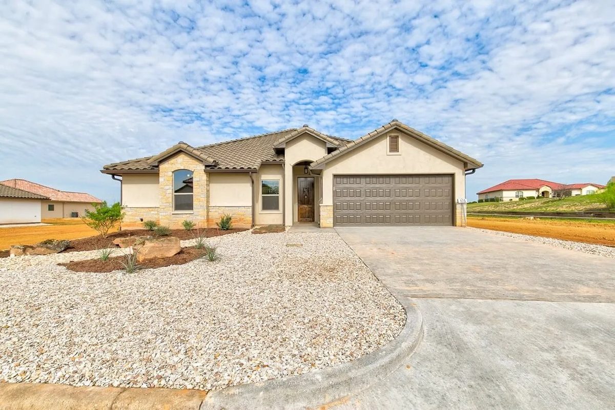 Tuscan-style stucco new construction home in Glen Rose, Texas